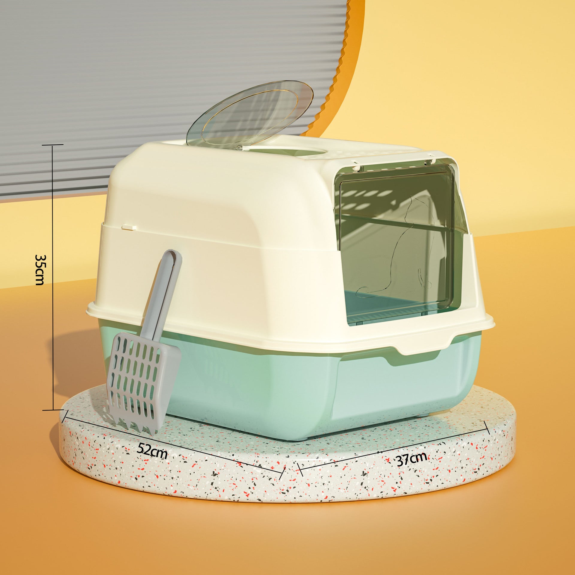 Pet litter box with a scoop on a yellow surface, showing dimensions.